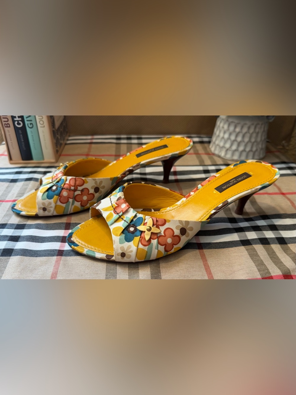 Louis Vuitton Vibrant Floral Mules with an LV Monogram Rivet.